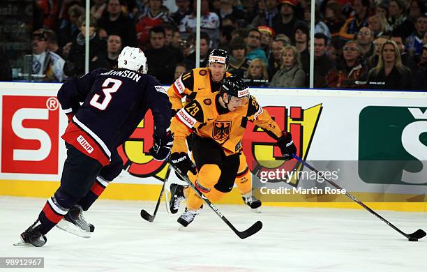 Alexander Barta of Germany and Jack Johnson of USA compete for the puck during the IIHF World Championship group D match between USA and Germany at...