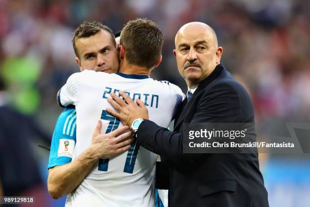 Igor Akinfeev of Russia hugs teammate Roman Zobnin after the 2018 FIFA World Cup Russia Round of 16 match between Spain and Russia at Luzhniki...