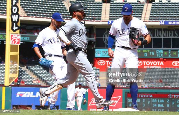 Joey Gallo of the Texas Rangers makes the out on first base against Yolmer Sanchez of the Chicago White Sox in the sixth inning at Globe Life Park in...