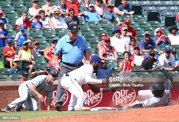 Joe West umpire and Nick Capra of the Chicago White Sox at Globe Life Park in Arlington on July third base coach looks on in the seventh inning as...