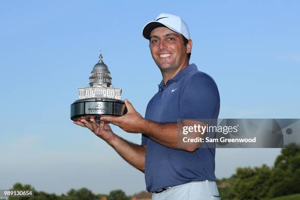 Francesco Molinari of Italy celebrates with the trophy after winning the Quicken Loans National during the final round at TPC Potomac on July 1, 2018...