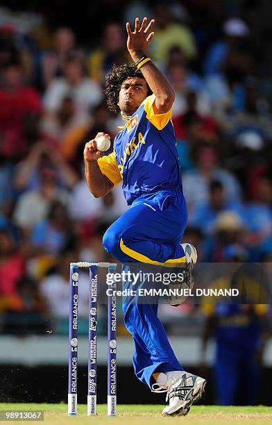 Sri Lankan bowler Lasith Malinga delivers during the ICC World Twenty20 Super Eight match between West Indies and Sri Lanka at the Kensington Oval on...