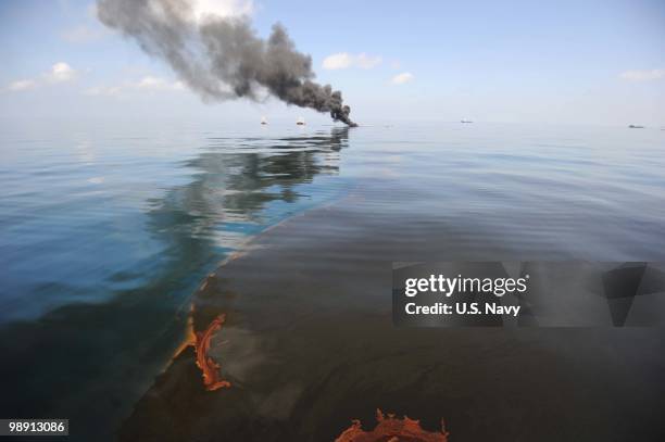 Oil burns during a controlled fire May 6, 2010 in the Gulf of Mexico. The U.S. Coast Guard is overseeing oil burns after the sinking, and subsequent...