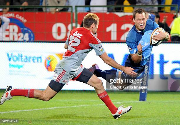 Francois Hougaard of the Bulls scores a try in front of Jared Payne of the Crusaders during the Super 14 round 13 match between Vodacom Bulls and...