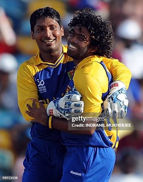 Sri Lankan cricketer Kumar Sangakkara embraces teammate Lasith Malinga after taking the wicket of West Indian cricketer Andre Fletcher during The ICC...