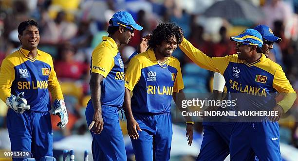 Sri Lankan cricketers congratulate teammate Lasith Malinga after taking the wicket of West Indian cricketer Andre Fletcher during The ICC World...