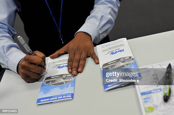 LaToya Dauphine helps a customer at the Thrifty rental car counter at Hartsfield-Jackson Atlanta International Airport in Atlanta, Georgia, U.S., on...