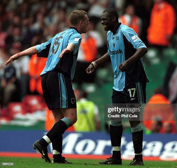 Michael Ricketts and Kevin Nolan of Bolton celebrate gaining promotion to the Premiership during the match between Bolton Wanderers and Preston North...