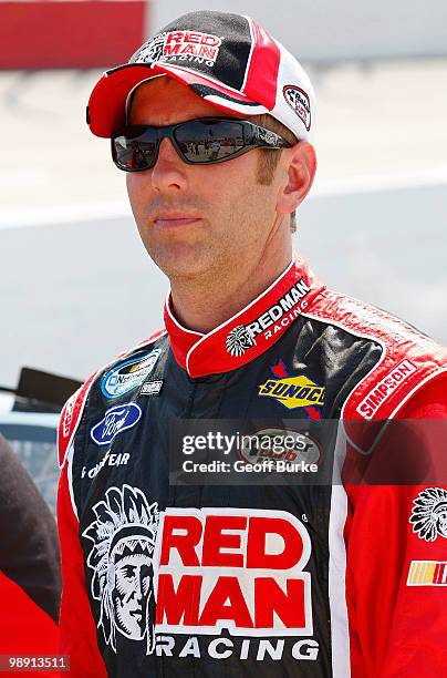 Greg Biffle, driver of the Red Man Moist Snuff Ford, stands on the grid during qualifying for the NASCAR Nationwide series Royal Purple 200 presented...