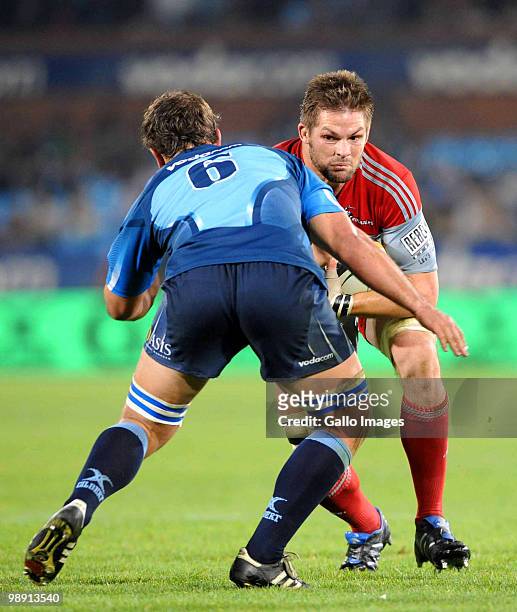 Richie McCaw of the Crusaders is tackled by Deon Stegmann of the Bulls during the Super 14 round 13 match between Vodacom Bulls and Crusaders at...