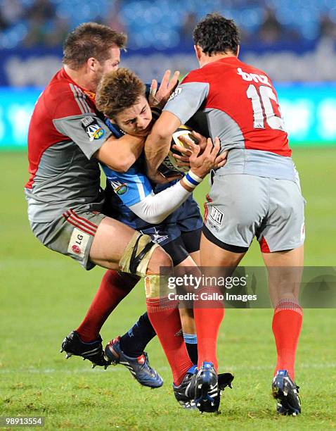 Richie McCaw and Dan Carter of the Crusaders tackle Gerhard van den Heever of the Bulls during the Super 14 round 13 match between Vodacom Bulls and...