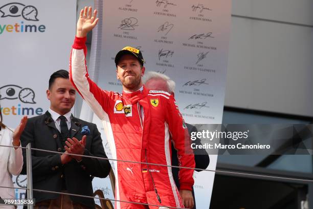 Third place finisher Sebastian Vettel of Germany and Ferrari celebrates on the podium after Formula One Grand Prix of Austria.