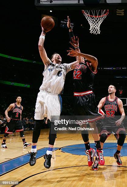 Mike Miller of the Washington Wizards puts a shot up against Taj Gibson of the Chicago Bulls during the game at the Verizon Center on April 2, 2010...