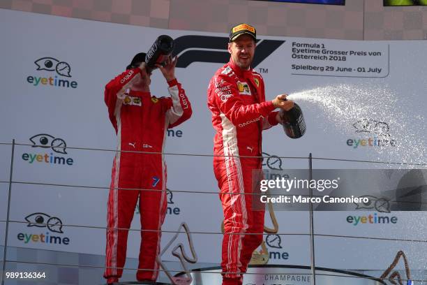 Third place finisher Sebastian Vettel of Germany and Ferrari celebrates on the podium after Formula One Grand Prix of Austria.