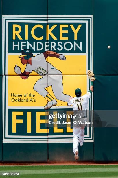 Dustin Fowler of the Oakland Athletics is unable to field a fly ball hit for an RBI double by Jose Ramirez of the Cleveland Indians during the fifth...