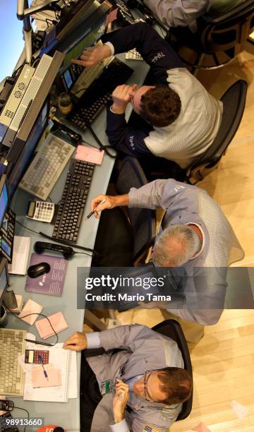 Traders work on the floor of the New York Stock Exchange before the closing bell May 7, 2010 in New York City. Stocks closed down nearly 140 points...