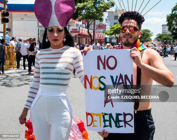 People with a sign reading "They are not going to stop us", take part in the Gay Pride Parade in San Jose on July 01, 2018.