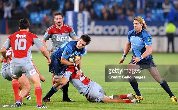 Stephan Dippenaar of the Bulls is tackled by Jared Payne of the Crusaders during the Super 14 round 13 match between Vodacom Bulls and Crusaders at...