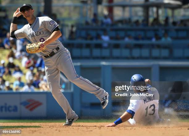 LeMahieu of the Colorado Rockies catches Austin Barnes of the Los Angeles Dodgers in a double play at second base in the seventh inning at Dodger...