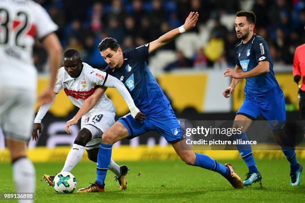 Hoffenheim's Benjamin Huebner and Stuttgart's Chadrac Akolo vie for the ball during the German Bundesliga soccer match between 1899 Hoffenheim and...