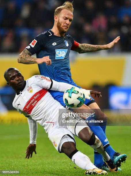 Stuttgart's Chadrac Akolo and Hoffenheim's Kevin Vogt vie for the ball during the German Bundesliga soccer match between 1899 Hoffenheim and VfB...