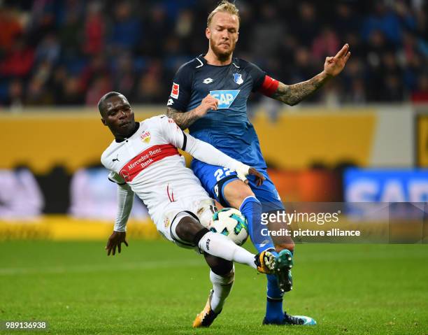 Stuttgart's Chadrac Akolo and Hoffenheim's Kevin Vogt vie for the ball during the German Bundesliga soccer match between 1899 Hoffenheim and VfB...