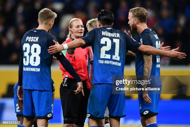 Referee Bibiana Steinhaus has an argument with Hoffenheim's Benjamin Huebner , Stefan Posch and Kevin Vogt during the German Bundesliga soccer match...