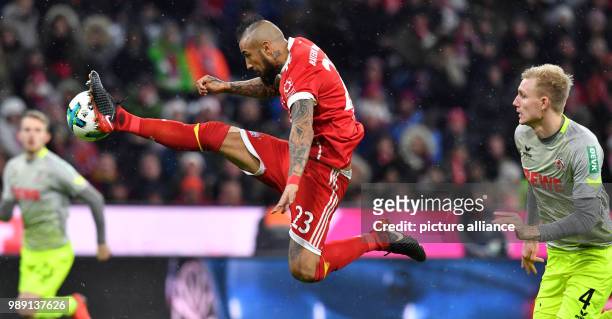 Munich's Arturo Vidal in action in front of Cologne's Frederik Soerensen during the German Bundesliga soccer match between Bayern Munich and 1. FC...