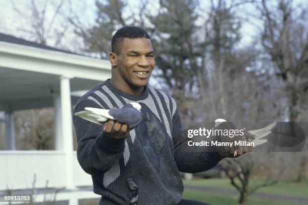 Casual portrait of Mike Tyson holding pigeons in each hand at the home of his surrogate mother Camille Ewald. Catskill, NY 12/1/1985 CREDIT: Manny...