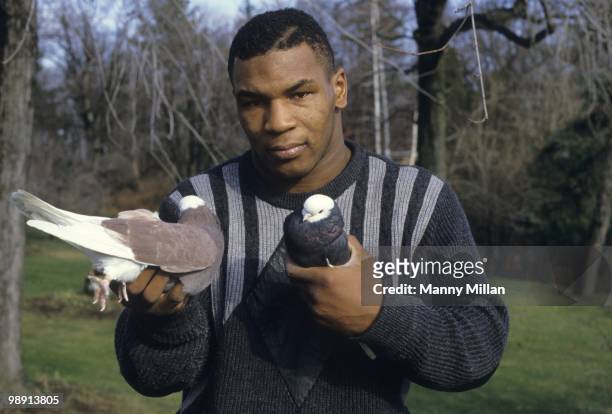 Casual portrait of Mike Tyson holding pigeons in each hand at the home of his surrogate mother Camille Ewald. Catskill, NY 12/1/1985 CREDIT: Manny...