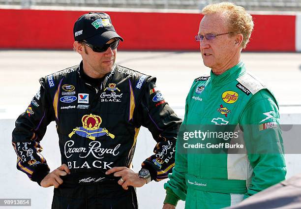 Matt Kenseth , driver of the Coupons.com Ford, talks with Morgan Shepherd , driver of the Racing with Jesus Chevrolet, on the grid during qualifying...