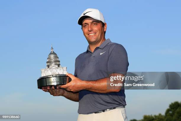 Francesco Molinari of Italy celebrates with the trophy after winning the Quicken Loans National during the final round at TPC Potomac on July 1, 2018...