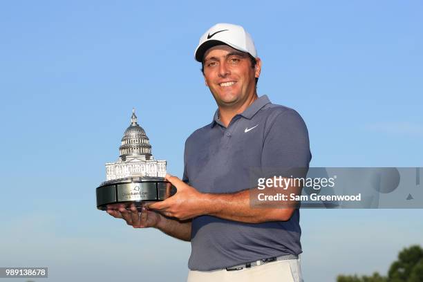 Francesco Molinari of Italy celebrates with the trophy after winning the Quicken Loans National during the final round at TPC Potomac on July 1, 2018...