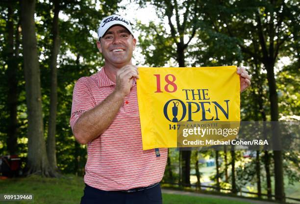 Ryan Armour of the United States holds an Open Championship hole flag after qualifying for the Open Championship during the fourth and final round of...