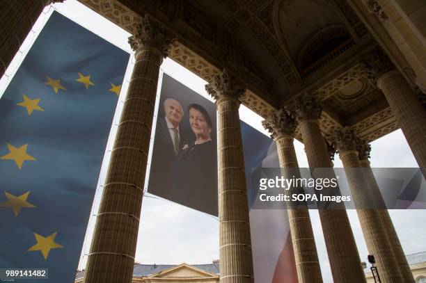 Portrait of Simone Veil hangs between two flags. The burial ceremony of former French politician and Holocaust survivor Simone Veil and her husband...
