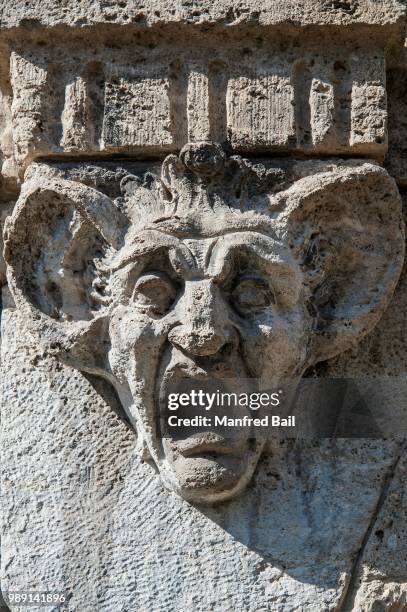 stone carving, head with huge ears and wide open mouth, munich, bavaria, germany - giant stone heads stock pictures, royalty-free photos & images