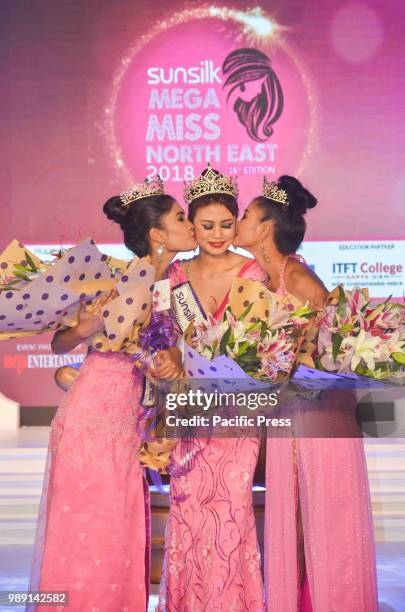 Winner Marian Longri , centre, 1st runner-up Tsurila , right, and 2nd runner-up Jyotishmita Baruah pose with their trophies during the grand finale...