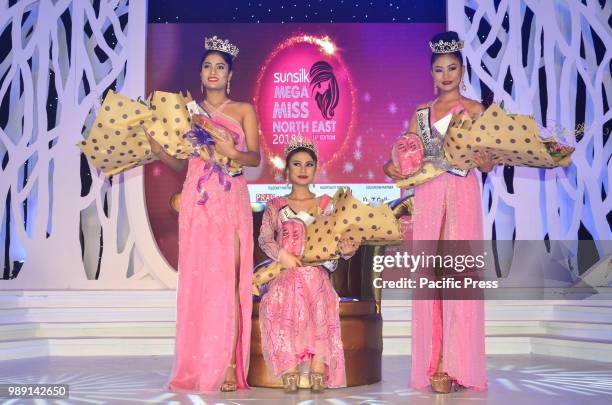 Winner Marian Longri , centre, 1st runner-up Tsurila , right, and 2nd runner-up Jyotishmita Baruah pose with their trophies during the grand finale...