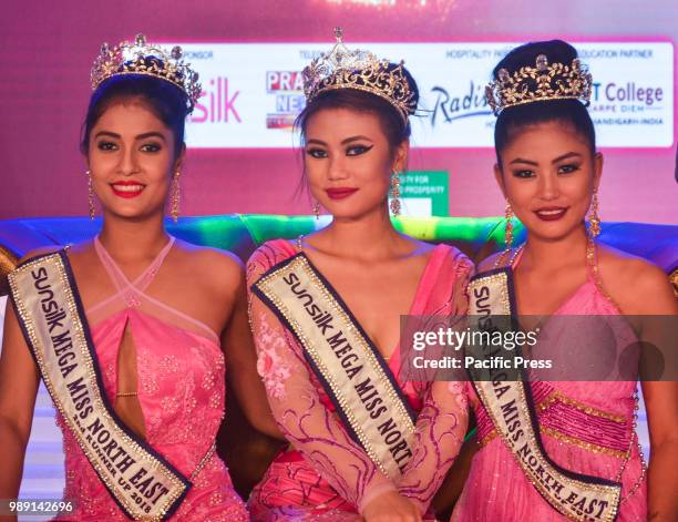Winner Marian Longri , centre, 1st runner-up Tsurila , right, and 2nd runner-up Jyotishmita Baruah pose with their trophies during the grand finale...