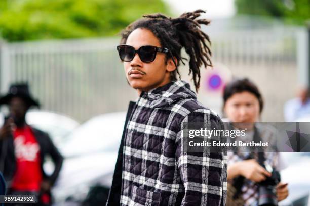 Luka Sabbat wears a black and white checked shirt , outside Vetements, during Paris Fashion Week Haute Couture Fall Winter 2018/2019, on July 1, 2018...