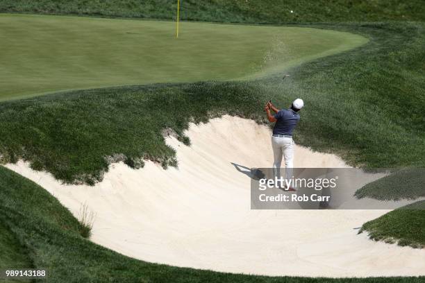 Francesco Molinari hits out of a bunker on the ninth hole during the final round of the Quicken Loans National at TPC Potomac on July 1, 2018 in...