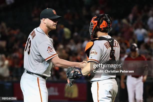 Relief pitcher Will Smith of the San Francisco Giants celebrates with catcher Nick Hundley after defeating the Arizona Diamondbacks 9-6 in the MLB...