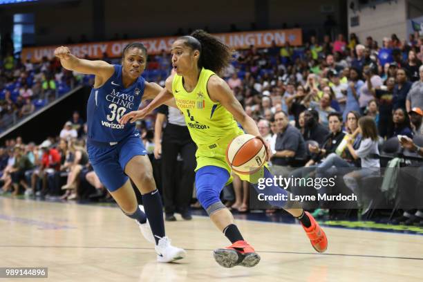 Skylar Diggins-Smith of the Dallas Wings handles the ball against Tanisha Wright of the Minnesota Lynx on July 1, 2018 at College Park Center in...