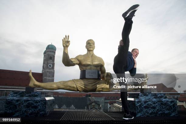 Actor Jean-Claude Van Damme poses during a press conference in Munich, 14 December 2017. Van Damme is going to play the lead character in Amazon's...