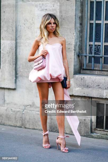 Erica Pelosini wears a pink dress, a pink bag , outside Givenchy, during Paris Fashion Week Haute Couture Fall Winter 2018/2019, on July 1, 2018 in...