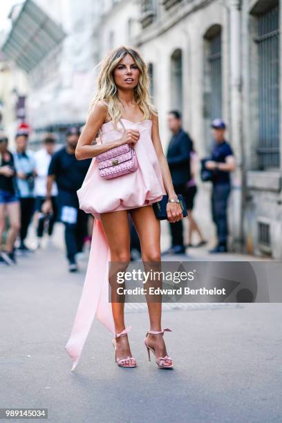 Erica Pelosini wears a pink dress, a pink bag , outside Givenchy, during Paris Fashion Week Haute Couture Fall Winter 2018/2019, on July 1, 2018 in...