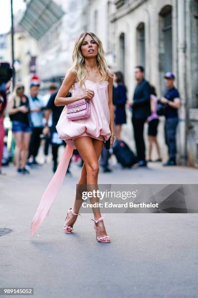 Erica Pelosini wears a pink dress, a pink bag , outside Givenchy, during Paris Fashion Week Haute Couture Fall Winter 2018/2019, on July 1, 2018 in...