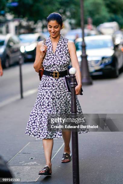 Caroline Issa wears a dress with white floral prints, a belt , outside Givenchy, during Paris Fashion Week Haute Couture Fall Winter 2018/2019, on...