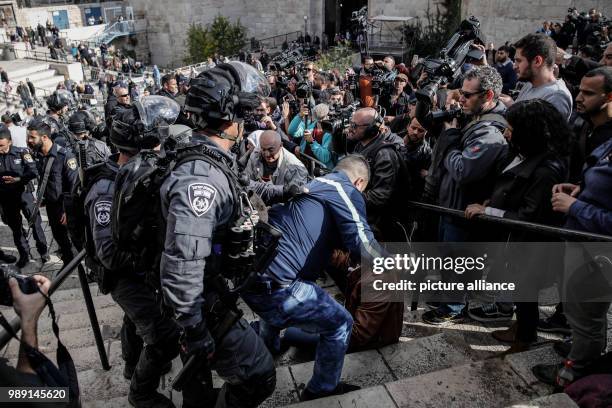 Israeli police officers scuffles with Palestinians protesters during a protest against the decision of US President Trump to recognize Jerusalem as...