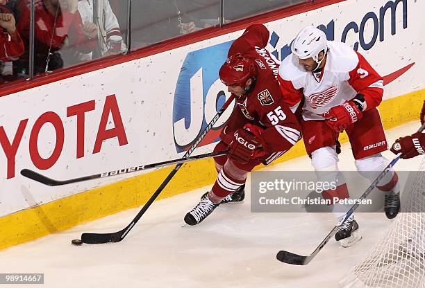 Ed Jovanovski of the Phoenix Coyotes skates with the puck against Andreas Lilja of the Detroit Red Wings in Game Five of the Western Conference...